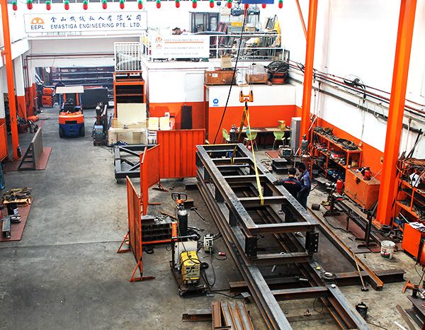 Inside the Emastiga workshop, with a long steel frame under fabrication