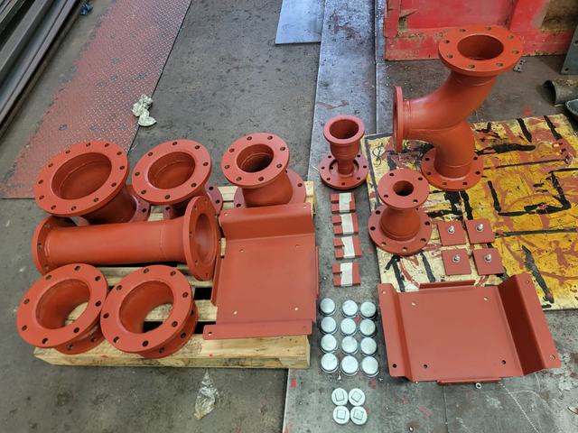 Red-painted flanged pipe spools, reducers and brackets