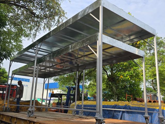 Mobile steel shelters on castors, loaded on a trailer