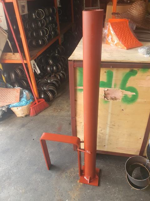Red-painted steel pipe post with a U-shaped bracket